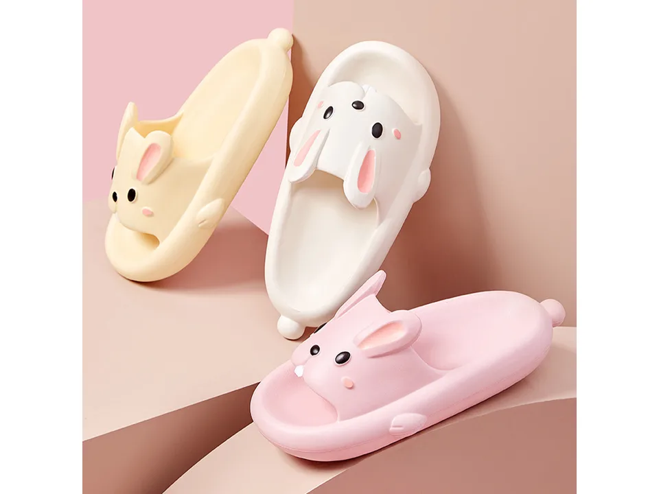 Three rabbit-themed slides in yellow, white, and pink arranged on a display.