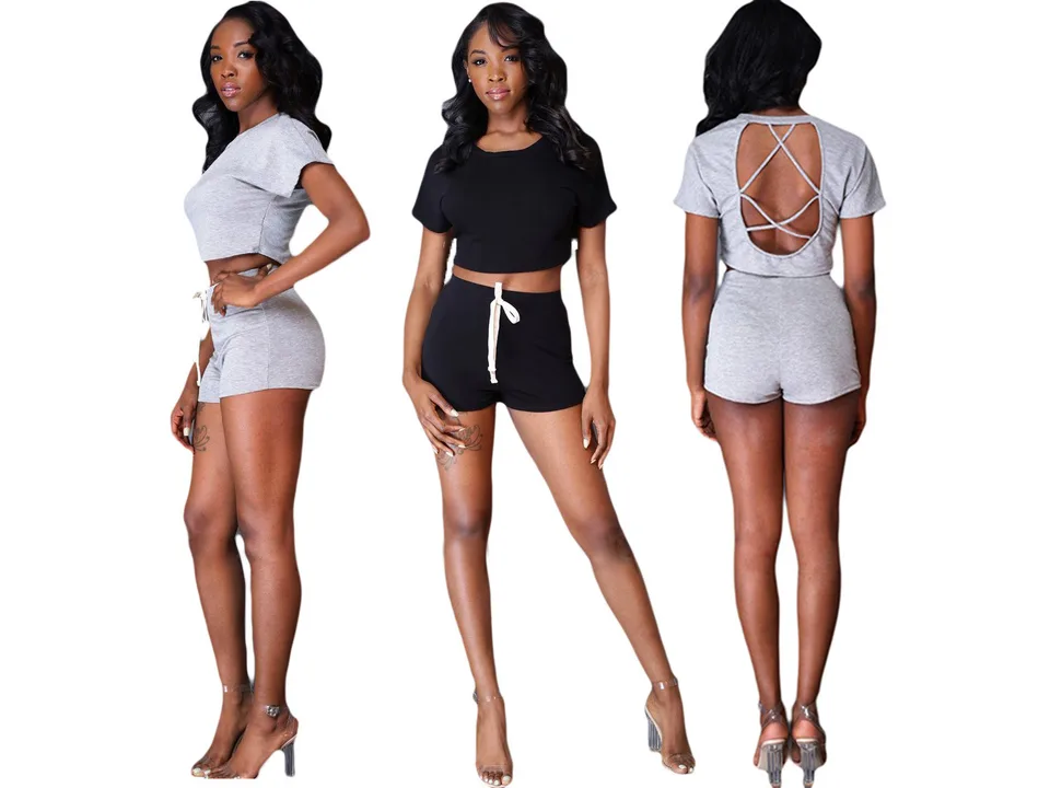 A model wearing a two-piece crop top and shorts set in grey and black, showing front, side, and back views.