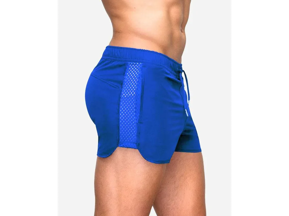 Side view of a man wearing royal blue athletic mesh shorts.