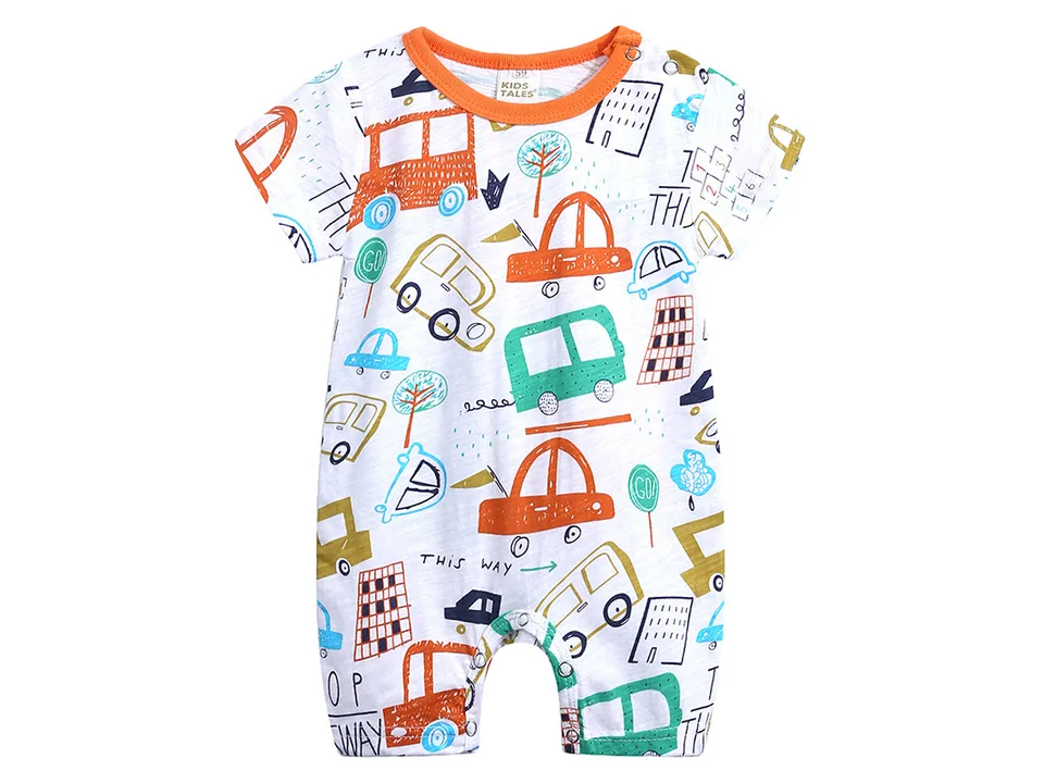 A white baby romper with a colorful car and city pattern.