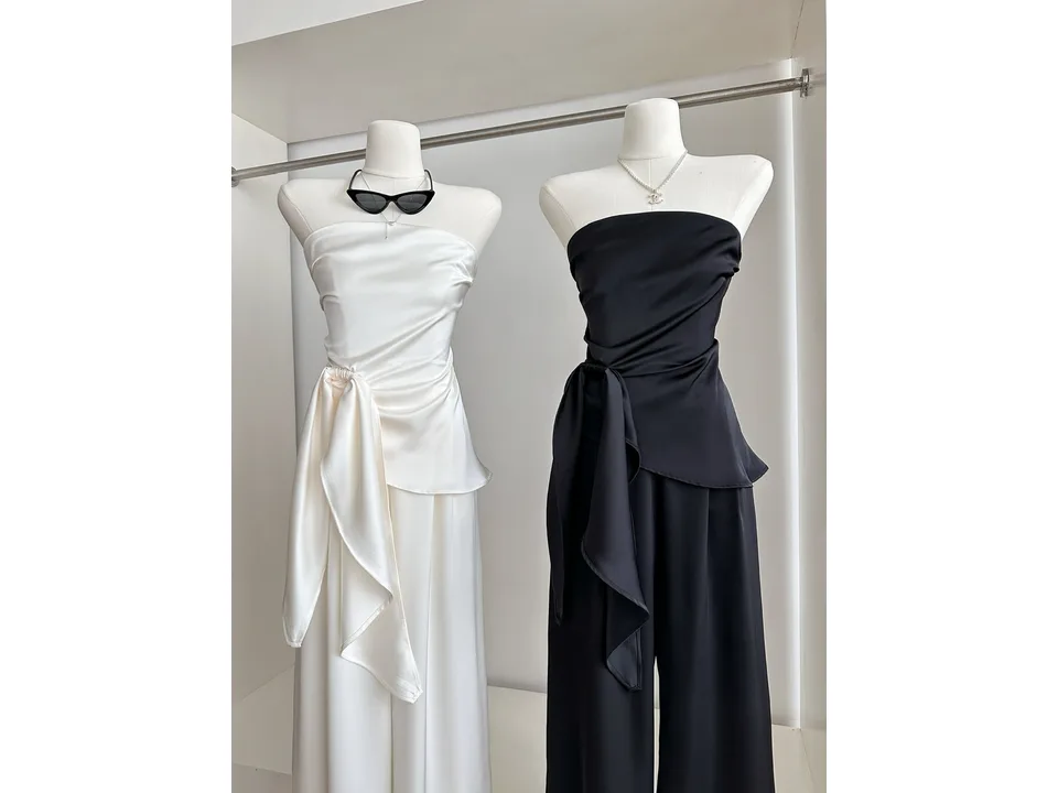 White and black tube top and wide leg trouser sets on mannequins