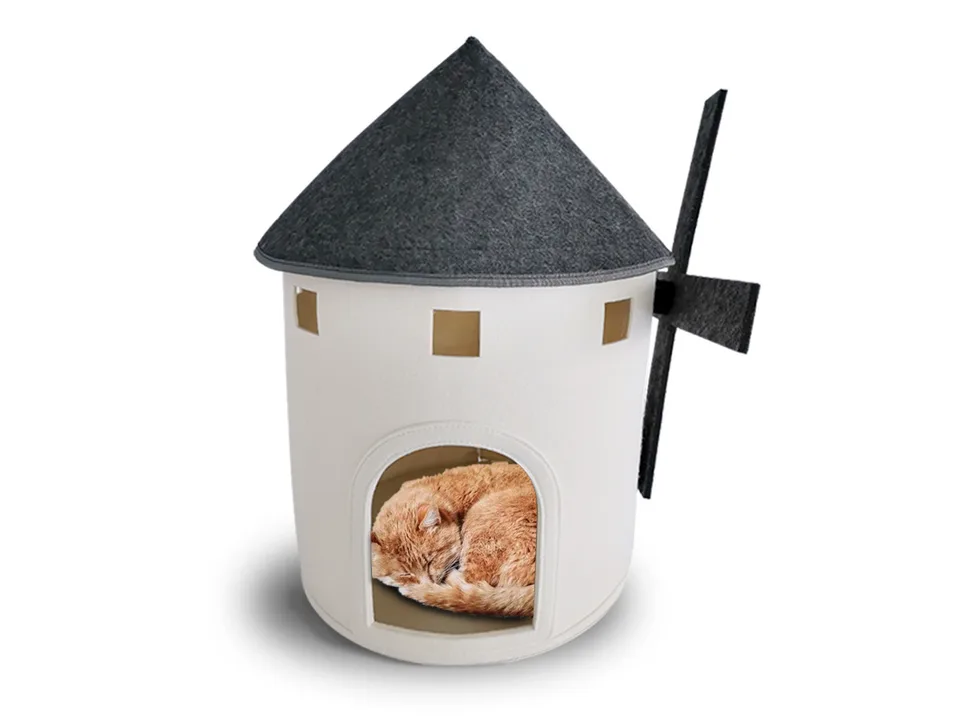 A ginger cat sleeping inside the windmill cat bed.