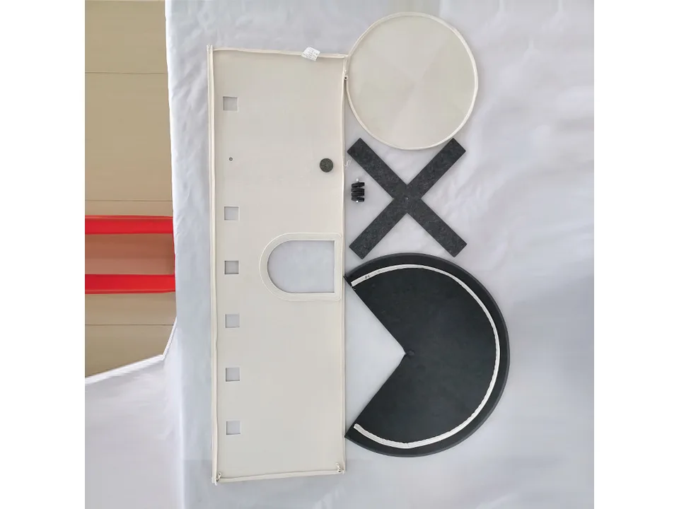 The disassembled parts of the windmill cat bed laid out on a white surface.