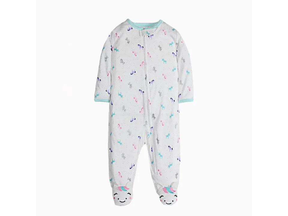 White baby onesie with unicorn pattern and unicorn face on the feet.
