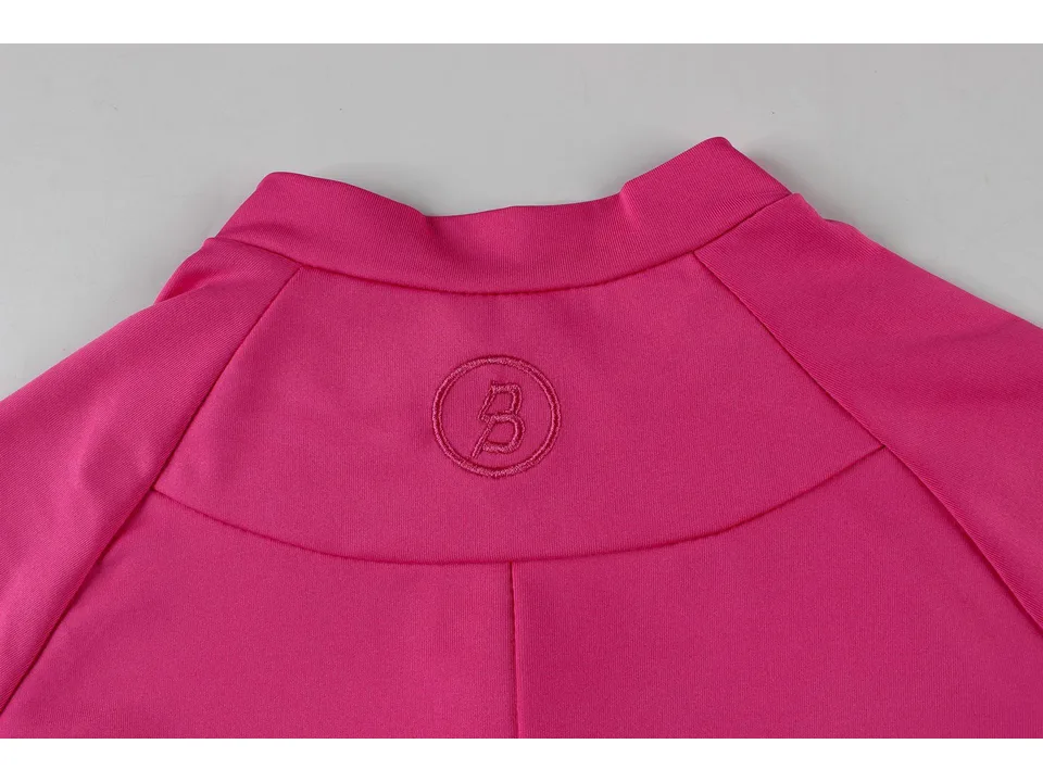 Close-up of the back of a pink yoga jumpsuit showing the embroidered logo.