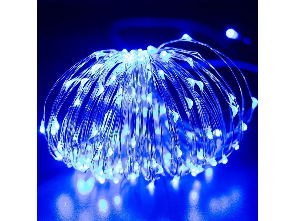Blue solar powered copper wire string lights glowing in the dark.