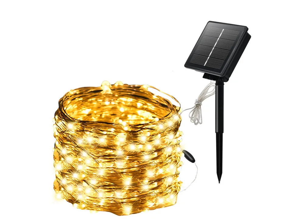 Solar powered copper wire string lights with a solar panel stake.