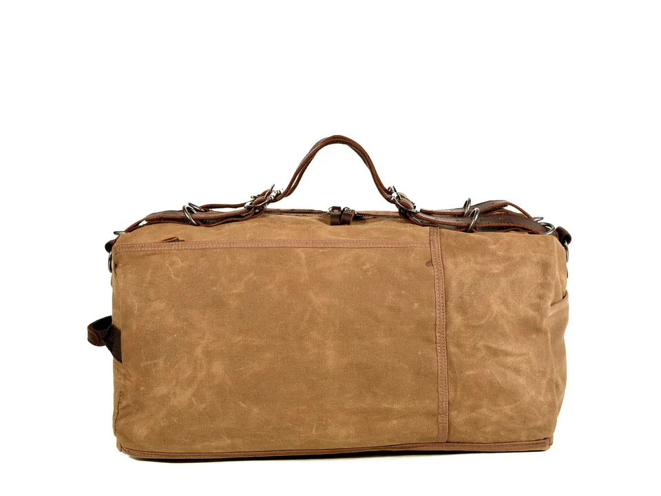 Brown canvas duffel bag with leather handles.
